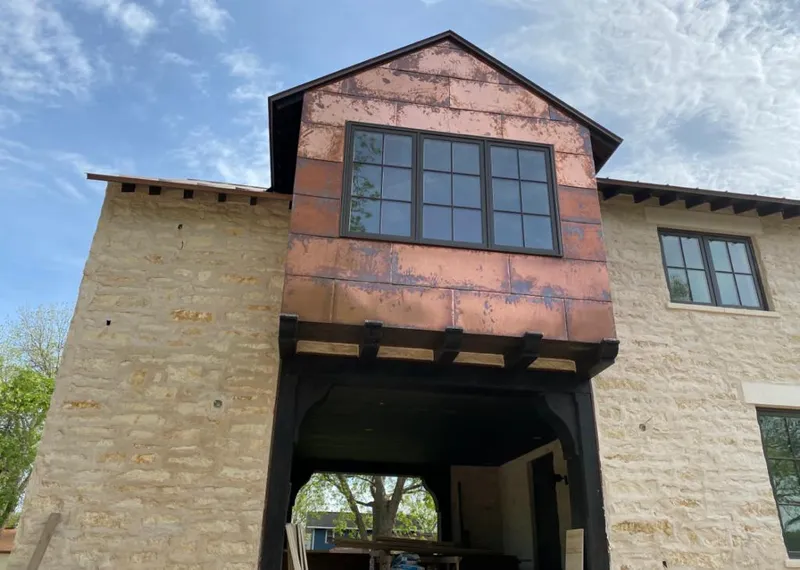 Copper metal panel facade on a stone building for Metal Roof Coating in Stone Ridge